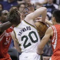 Utah Jazz guard Gordon Hayward (20) is fouled by Houston Rockets guard Jeremy Lin (7) as Rockets forward Patrick Patterson (54) defends during the second quarter of an NBA basketball game Monday, Nov. 19, 2012, in Salt Lake City. The Jazz won 102-91.